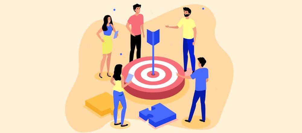 Team gathered around a bullseye target with an arrow, illustrating setting clear business goals for a loyalty program
